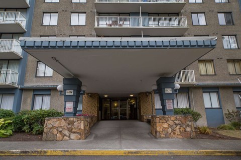 The entrance to a building with a stone pillar on either side.