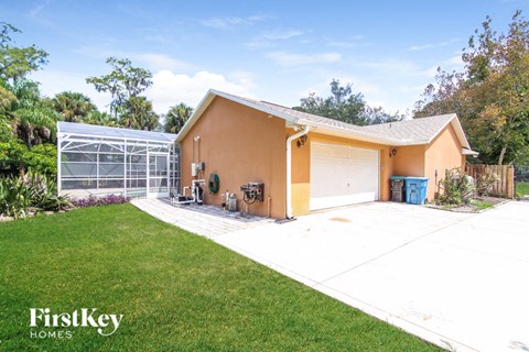 A house with a garage and a driveway in front of it.