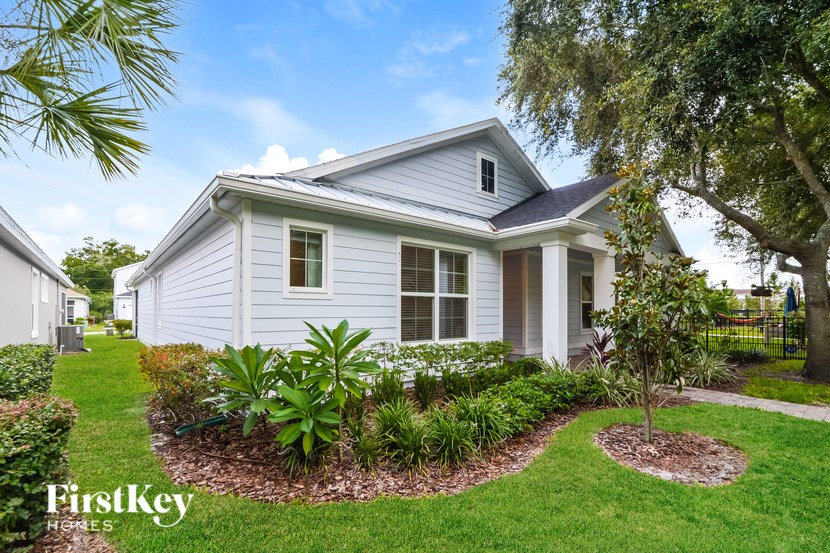 A house with a well-maintained lawn and garden in front.