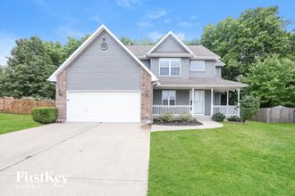 a home with a white garage door and a lawn