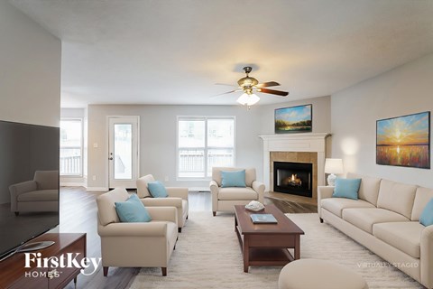 A living room with a fireplace and a painting on the wall.