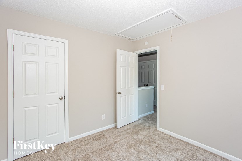 a bedroom with two closets and a door to a bathroom