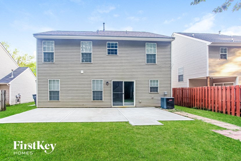 a white house with a yard and a driveway