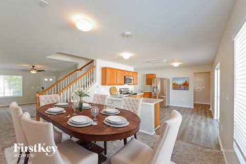 A dining room with a wooden table set for six.