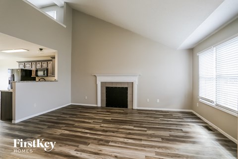 a living room with wood floors and a fireplace