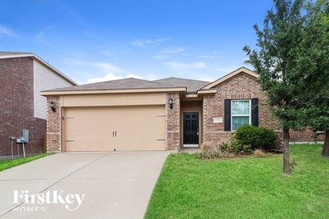 a brick house with a garage and a driveway