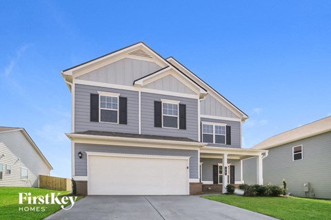 a gray house with a white garage door