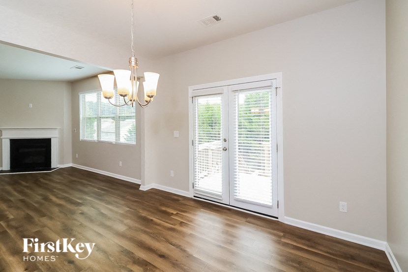 A room with a fireplace and sliding glass doors.