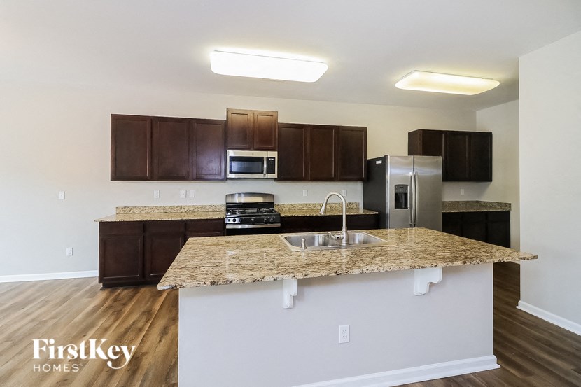 A kitchen with a granite countertop and a sink.