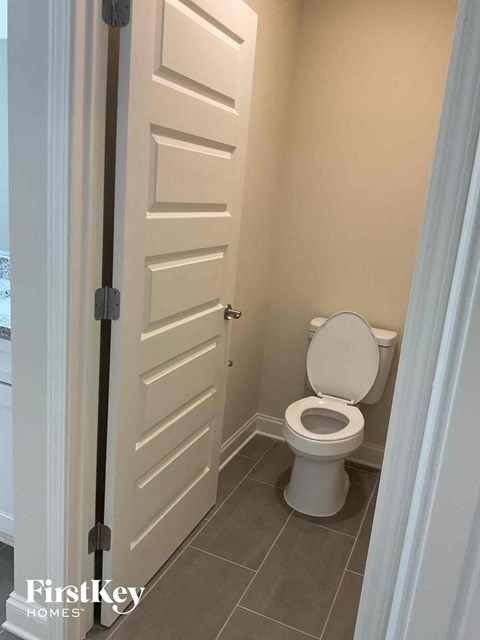 a small bathroom with a toilet and a white door