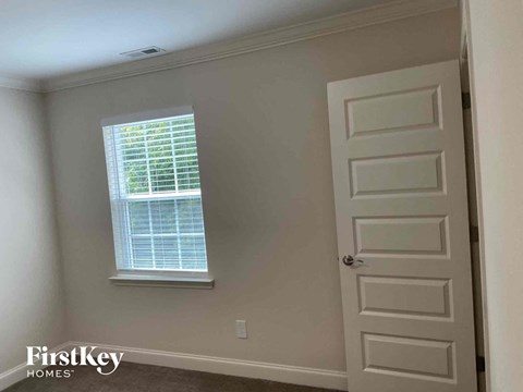a window and a door in a room with a white door