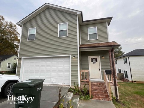a gray house with a white garage door