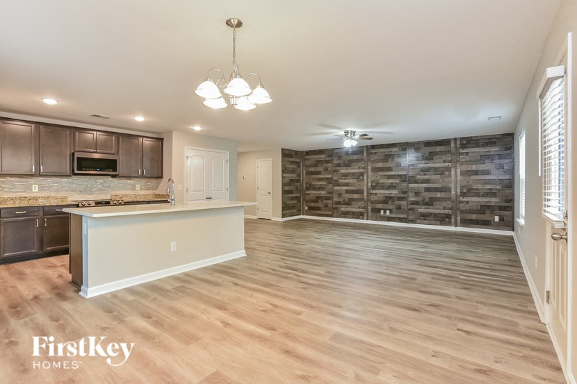 A spacious kitchen with wooden floors and a large island.