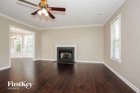 the living room with wood flooring and a fireplace