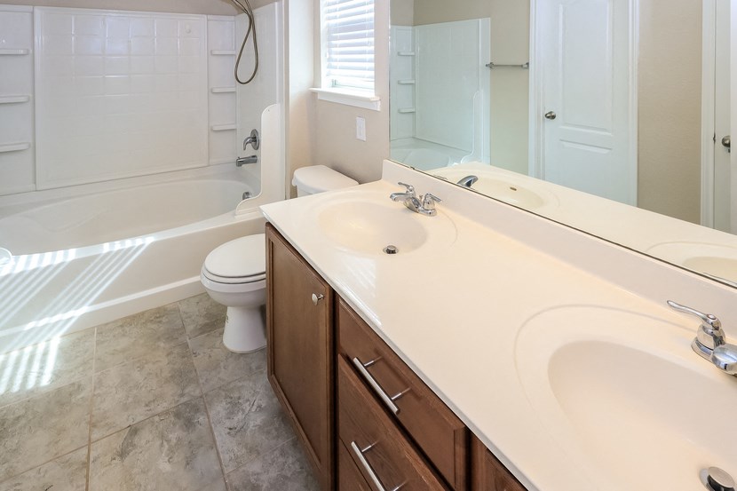 A white toilet sits next to a sink in a bathroom.