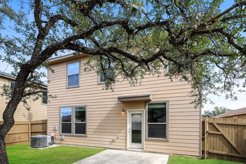 A house with a tree in front of it.