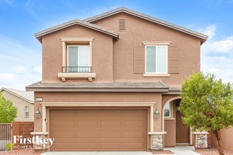 a brown house with a brown garage door