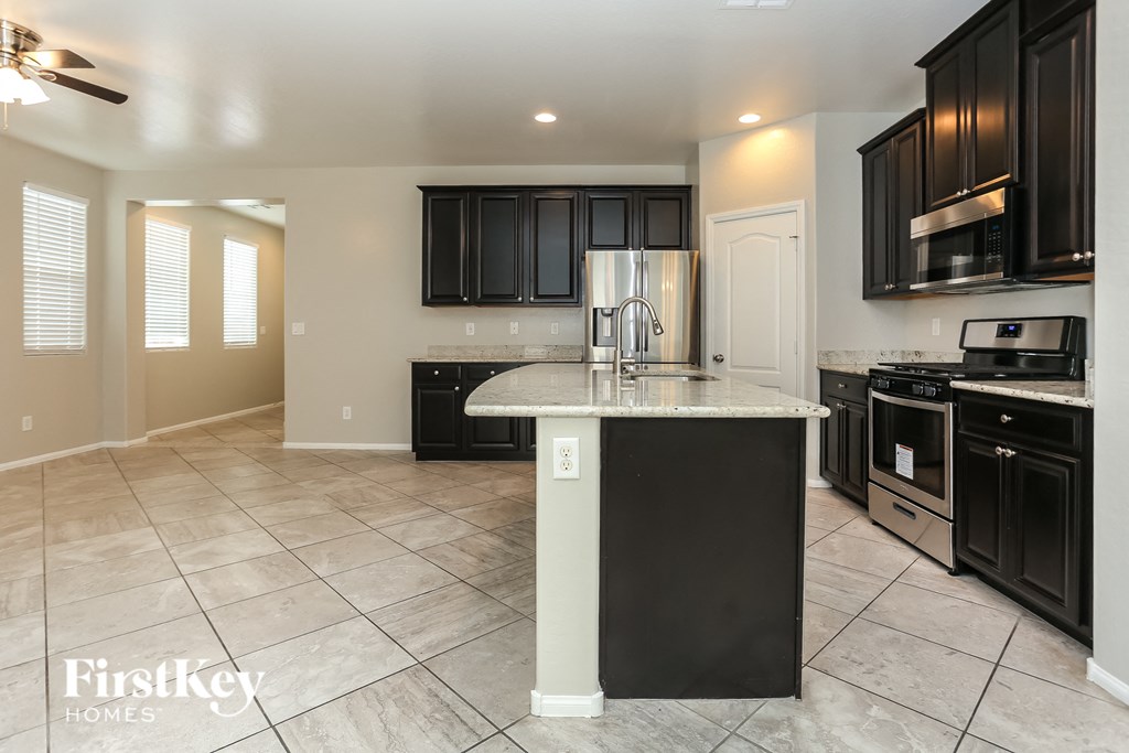 a kitchen with black cabinets and a counter top