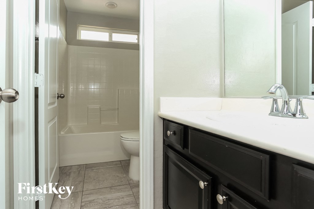 a bathroom with a shower and a sink and a mirror