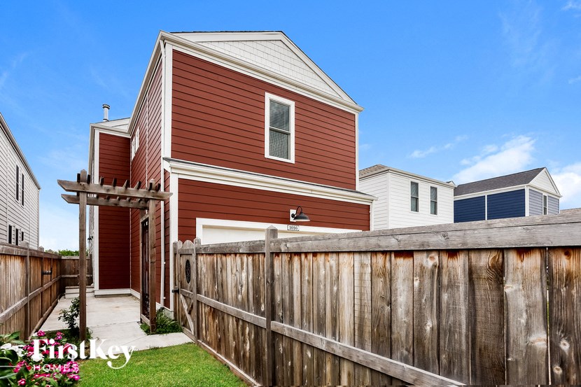 a house with a wooden fence in front of it