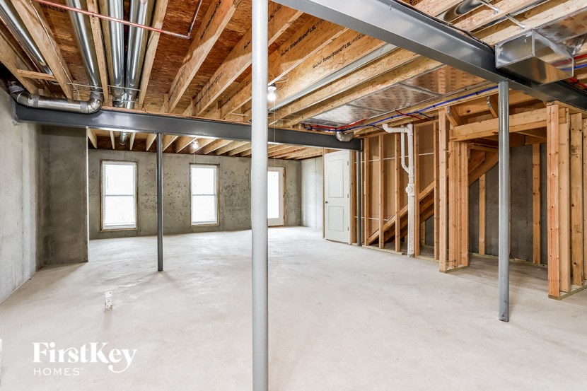 a large basement with unfinished wood and steel beams