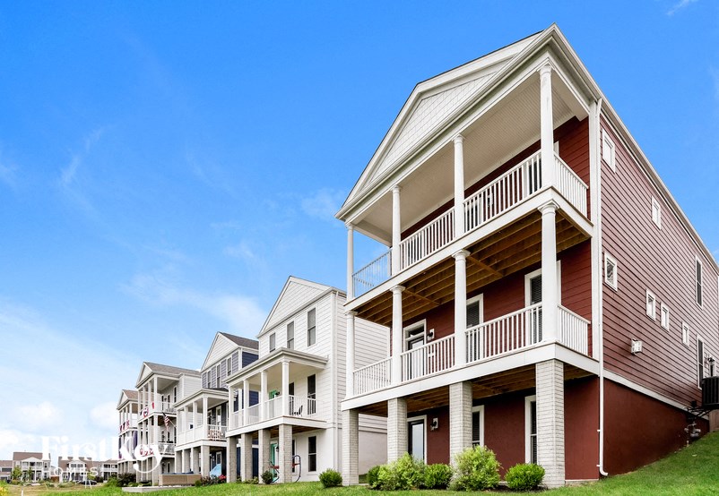a row of red and white houses with balconies