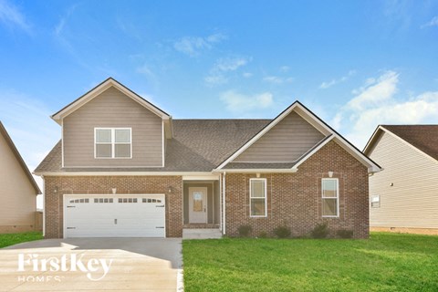 a brick house with a lawn in front of it