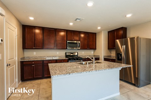 a kitchen with granite counter tops and stainless steel appliances