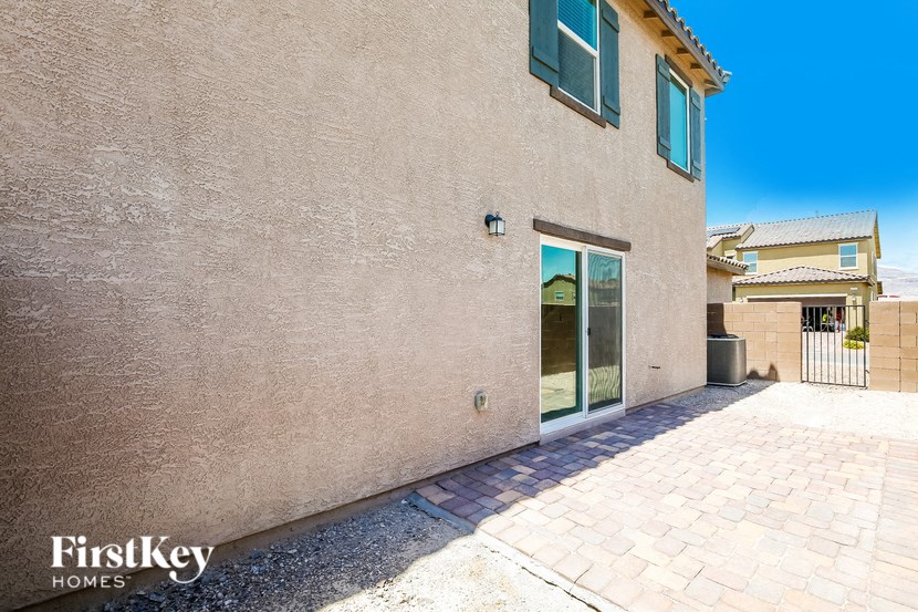 a brick building with an open door and a brick sidewalk