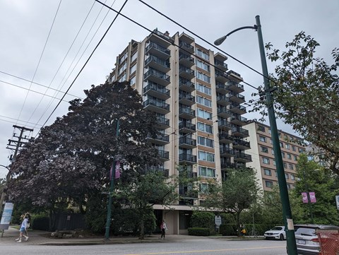 an apartment building on the corner of a street