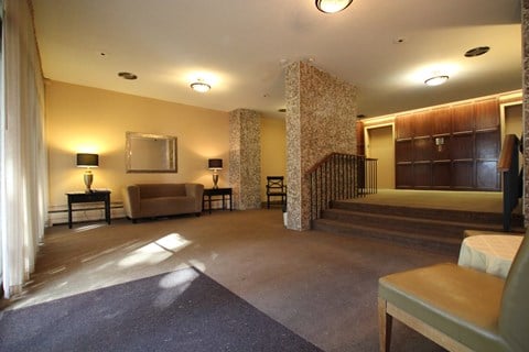 a large living room with a staircase and a couch