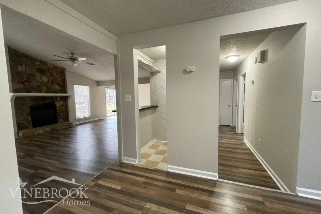 a living room with a wood floor and a fireplace