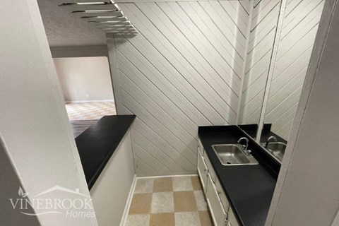 a small kitchen with a sink and a window