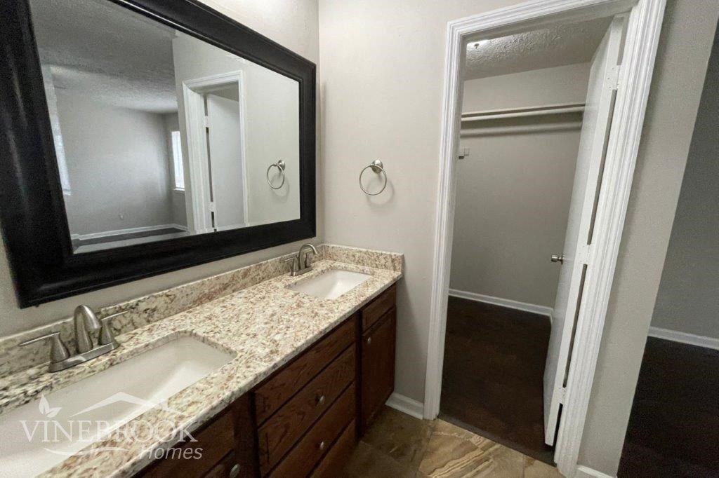 a bathroom with two sinks and a large mirror