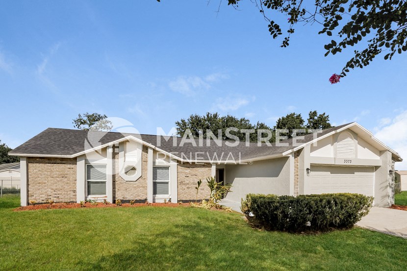 a small house with a lawn in front of it