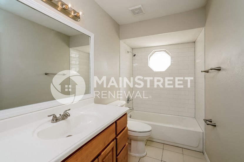 a bathroom with a sink and a toilet and a shower