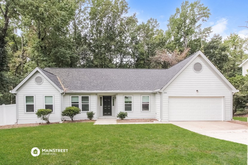 a white house with a lawn in front of it