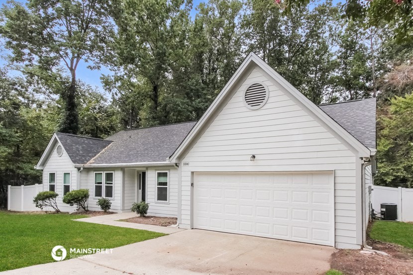 a white house with a white garage and a driveway