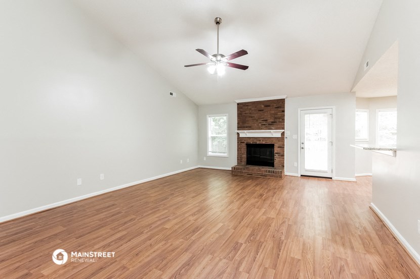 the living room with wood flooring and a fireplace