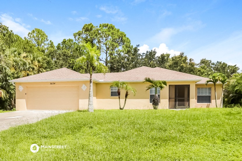 a yellow house with palm trees in front of it