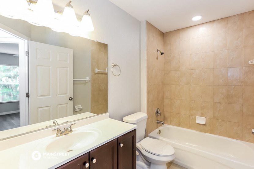 a bathroom with a sink and a toilet and a tub