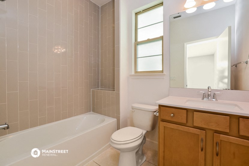a bathroom with a toilet and a sink and a bath tub