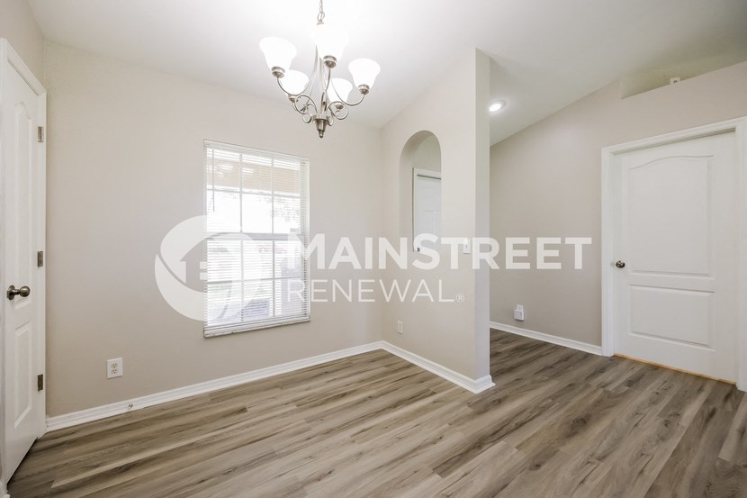 a living room with a white door and a window