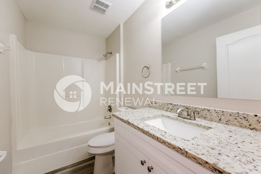 a bathroom with a sink and a toilet and a shower