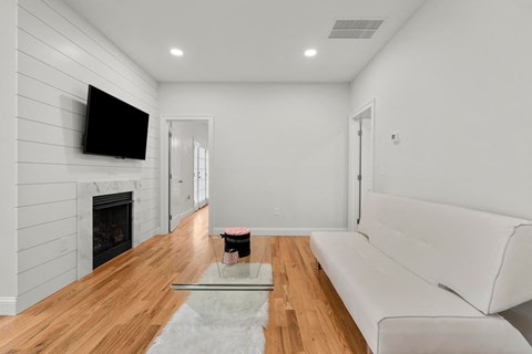 a living room with a white couch and a fireplace