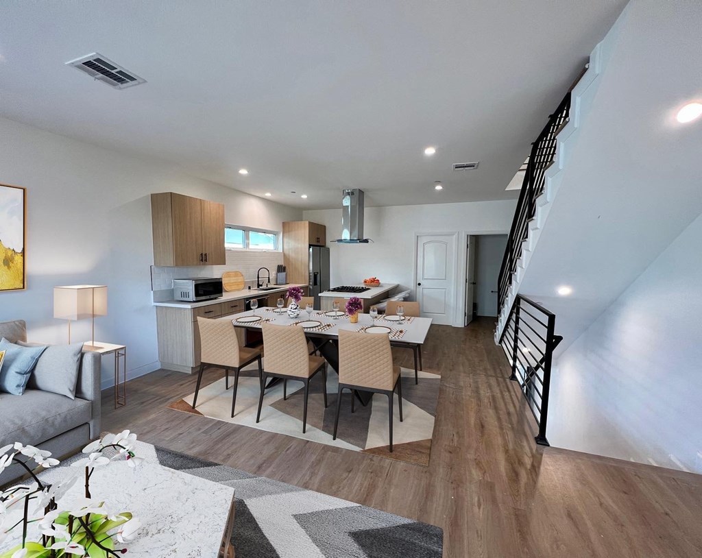 a living room with a dining room table and a kitchen