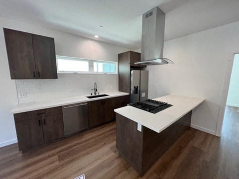 a kitchen with a white counter top and a refrigerator