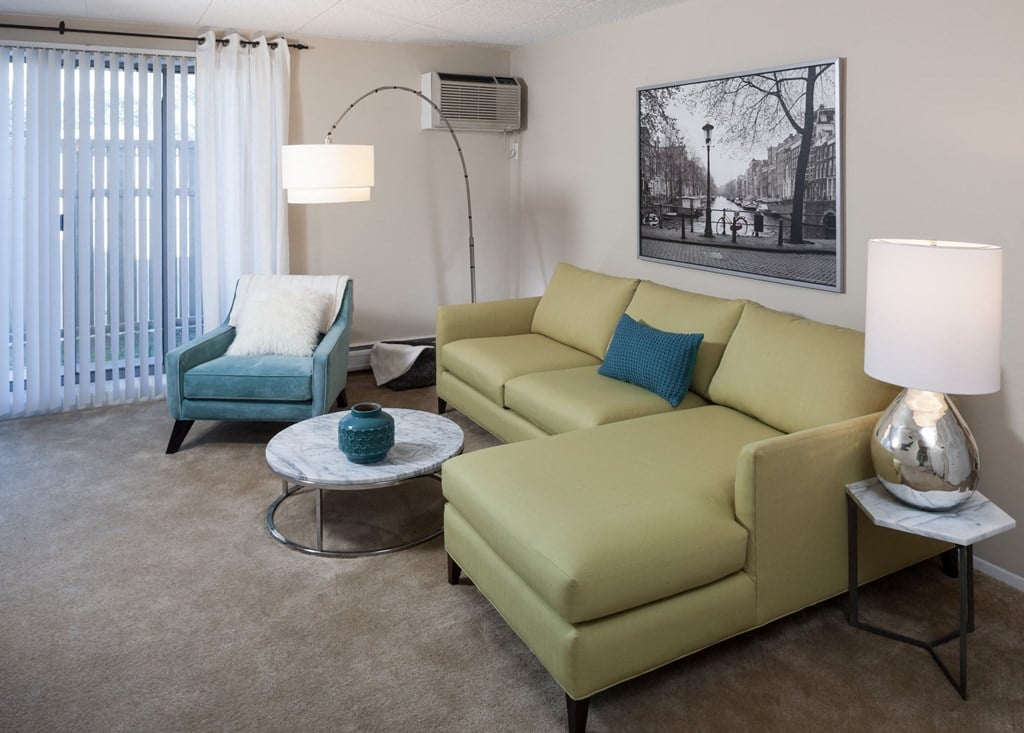 a living room with a couch and chair and a coffee table