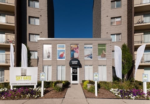 an apartment building with a walkway and a sign in front of it