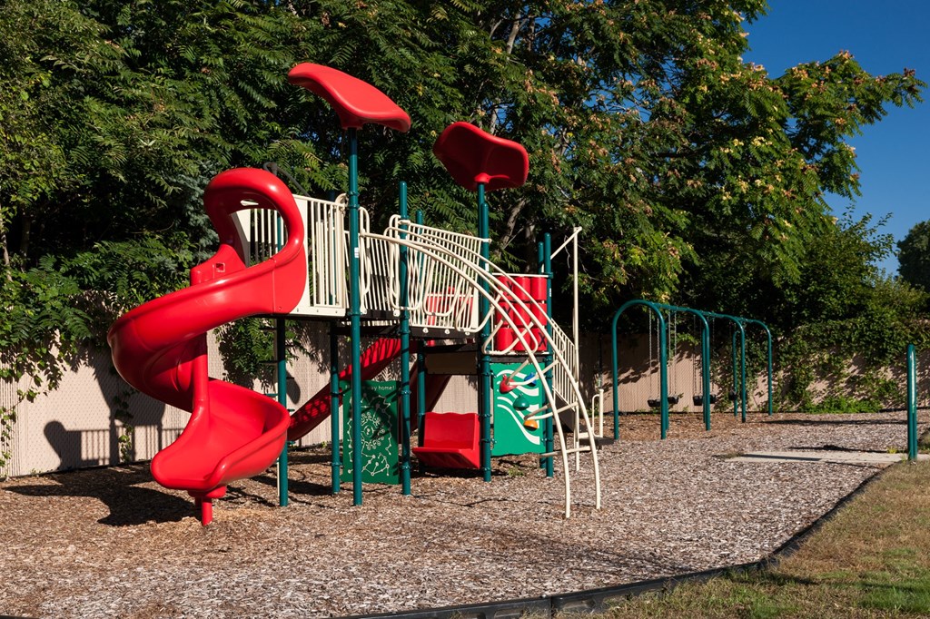 a playground with a slide and other playground equipment
